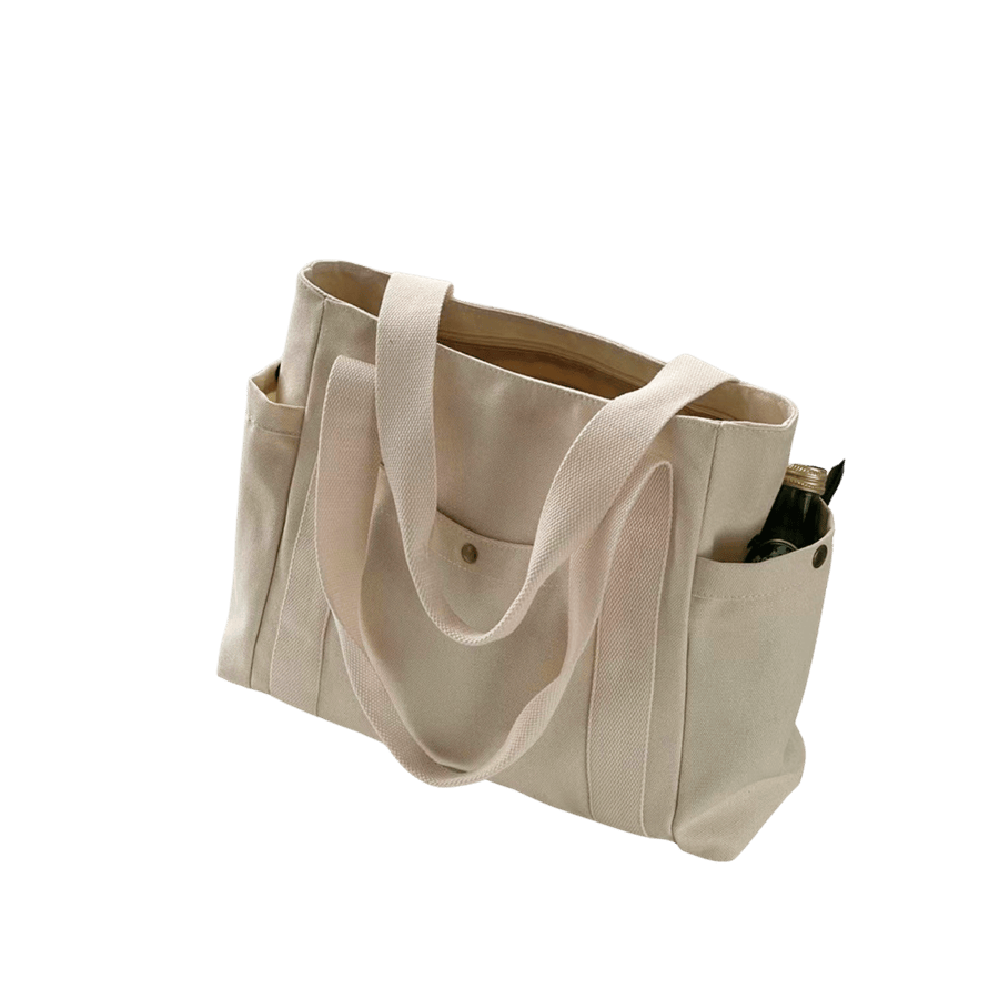 Beige canvas ladies tote with side pockets and front pocket