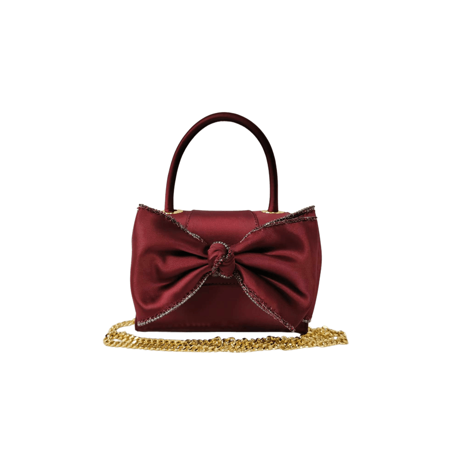 Burgundy ladies handbag with big bowknot and decorative eyelets on the top