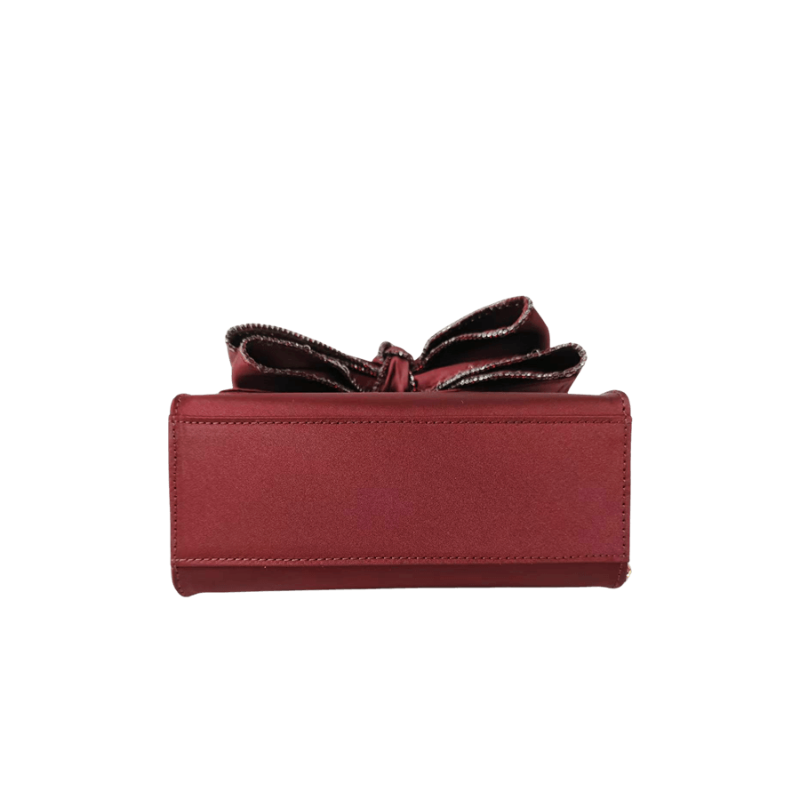 Burgundy ladies handbag with big bowknot and decorative eyelets on the top