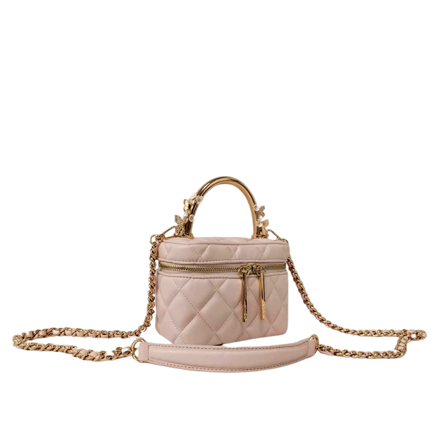 Pink quilting ladies handbag with metal handle and decorative flowers on the handle