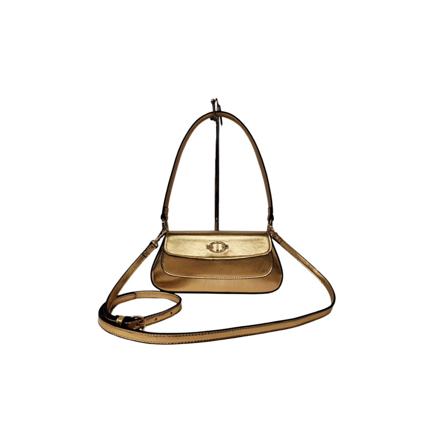 Gold ladies handbag with decorative hardware on the flap and magnetic snap closure