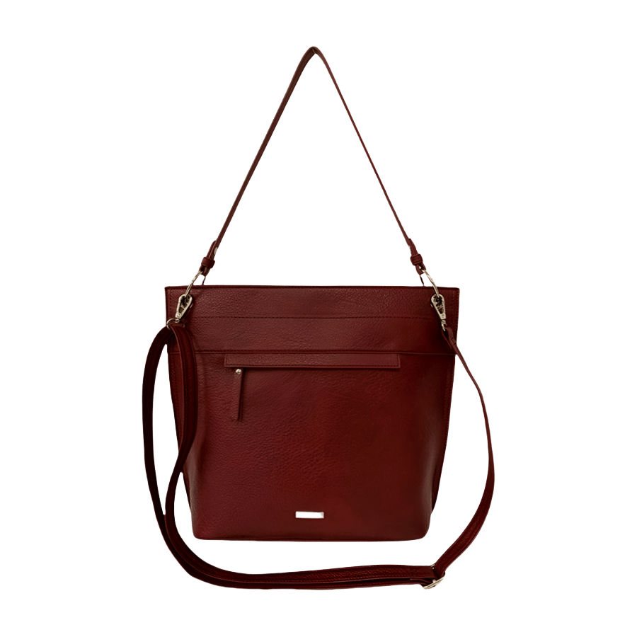 Green ladies handbag with front zip pocket and metal plate