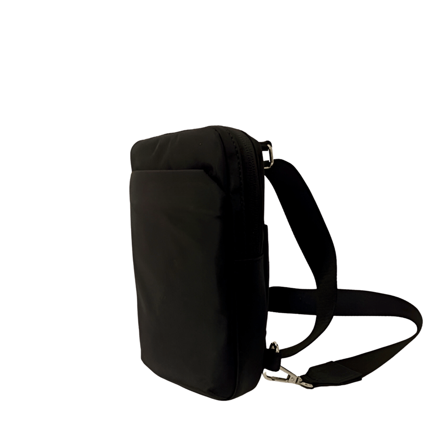 Black sling bag with front zip pocket and top zip closure