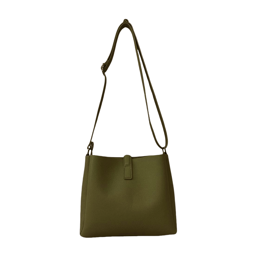 Green ladies crossbody bag with magnetic snap closure and decorative stud on the small flap