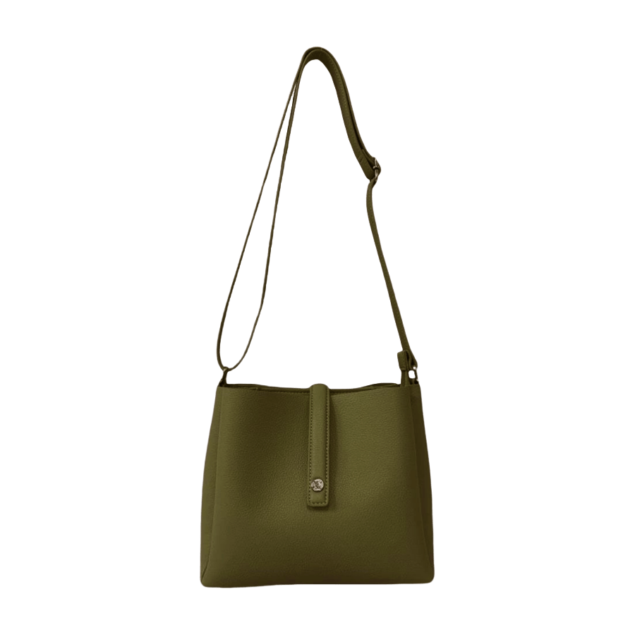 Green ladies crossbody bag with magnetic snap closure and decorative stud on the small flap