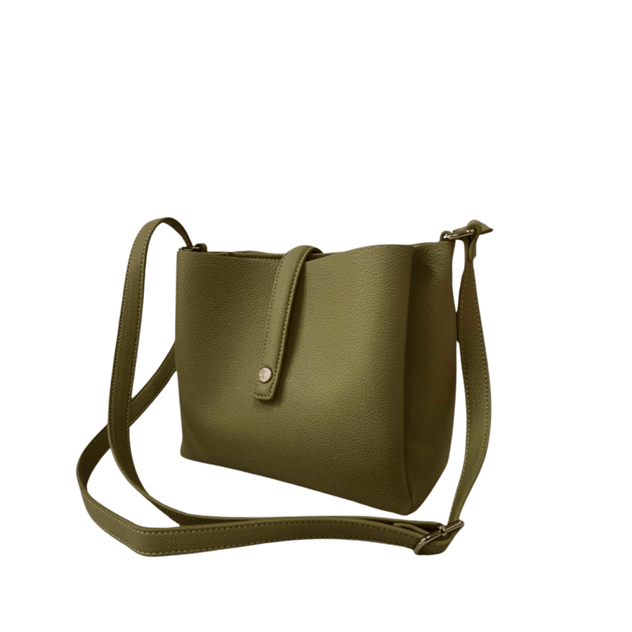 Green ladies crossbody bag with magnetic snap closure and decorative stud on the small flap