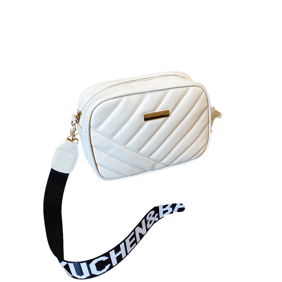 White quilting ladies crossbody bag with decorative metal plate and printing on the webbing shoulder strap