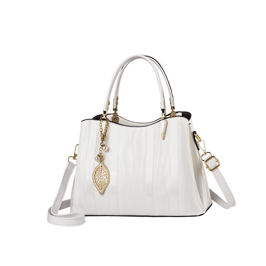 White ladies handbag with metal leaf hangtag and tab of handle