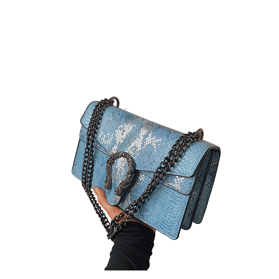 Blue snake PU ladies crossbody bag with decorative hardware on the flap and magnetic snap closure