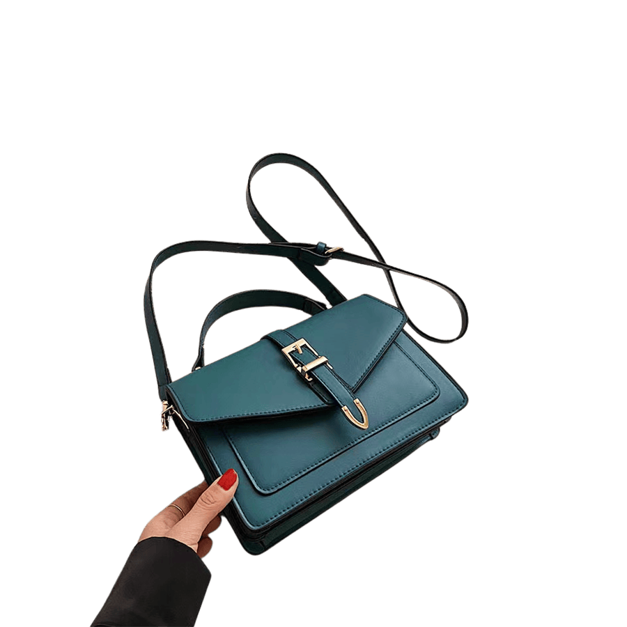 Green ladies handbag with decorative hardwares on the flap and contrast edge painting