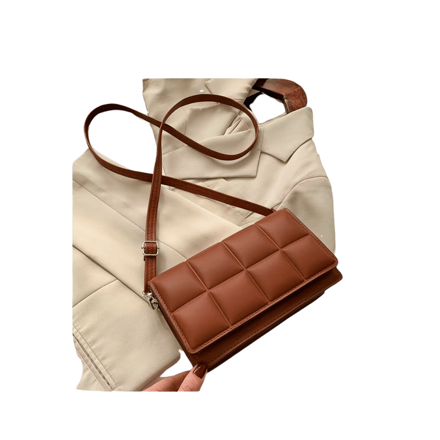 Brown quilting ladies crossbody bag with stitching on the shoulder strap and magnetic snap closure