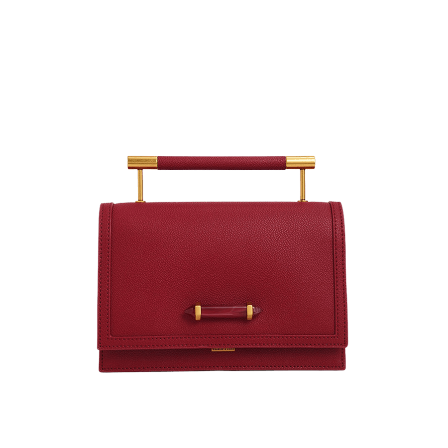 Red ladies handbag with metal handle and decorative acrylic