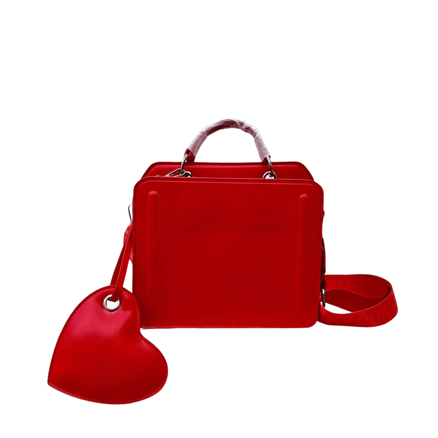 Red ladies handbag with detachable heart-shaped bag and decorative bombe