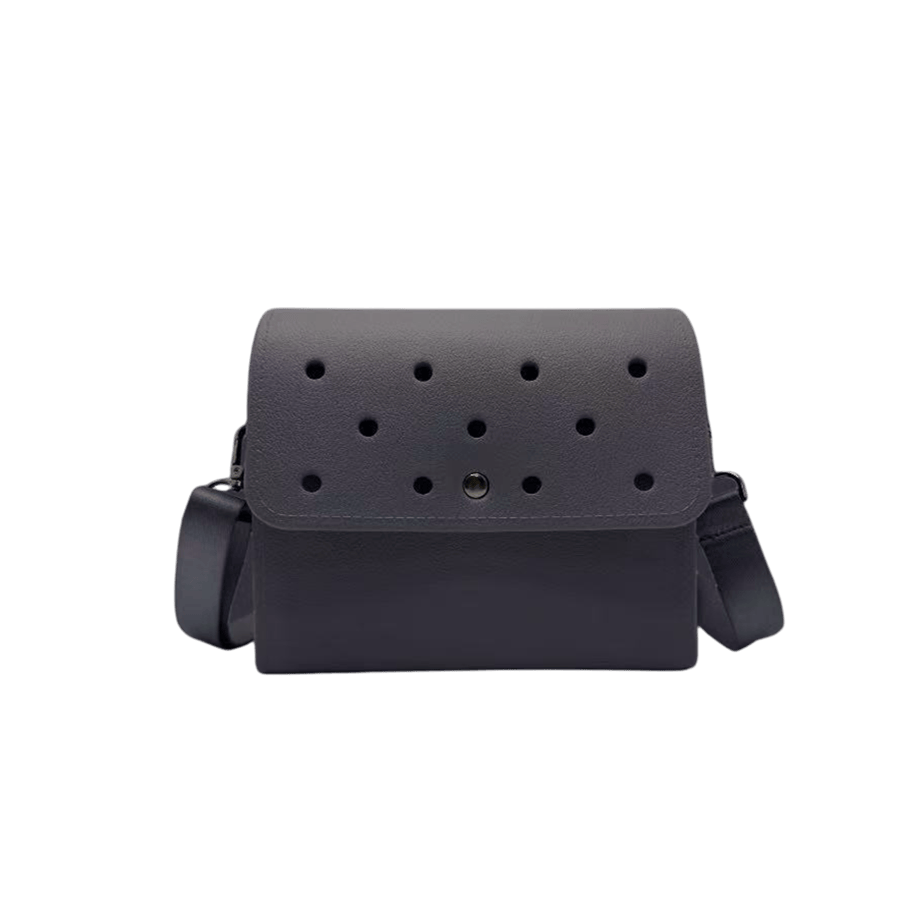 Grey ladies crossbody bag with holes on the flap and magnetic snap closure