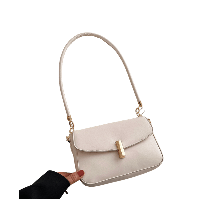 White ladies handbag with lock closure and decorative chain on the handle