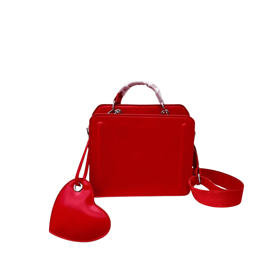 Red ladies handbag with detachable heart-shaped hangtag and decorative bombe