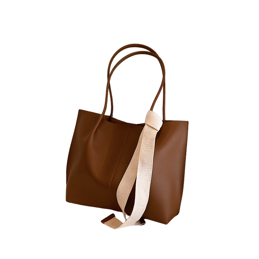 Brown ladies tote with decorative webbing on the handle