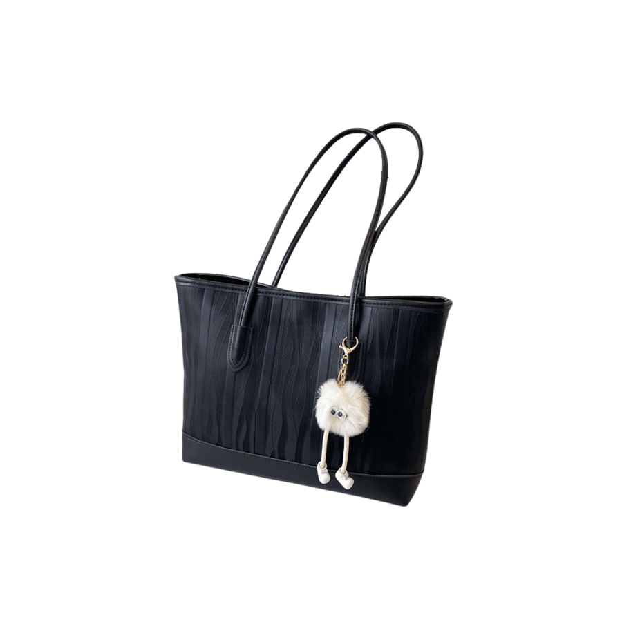 Black ladies tote bag with detachable white toy pompom and magnetic snap closure