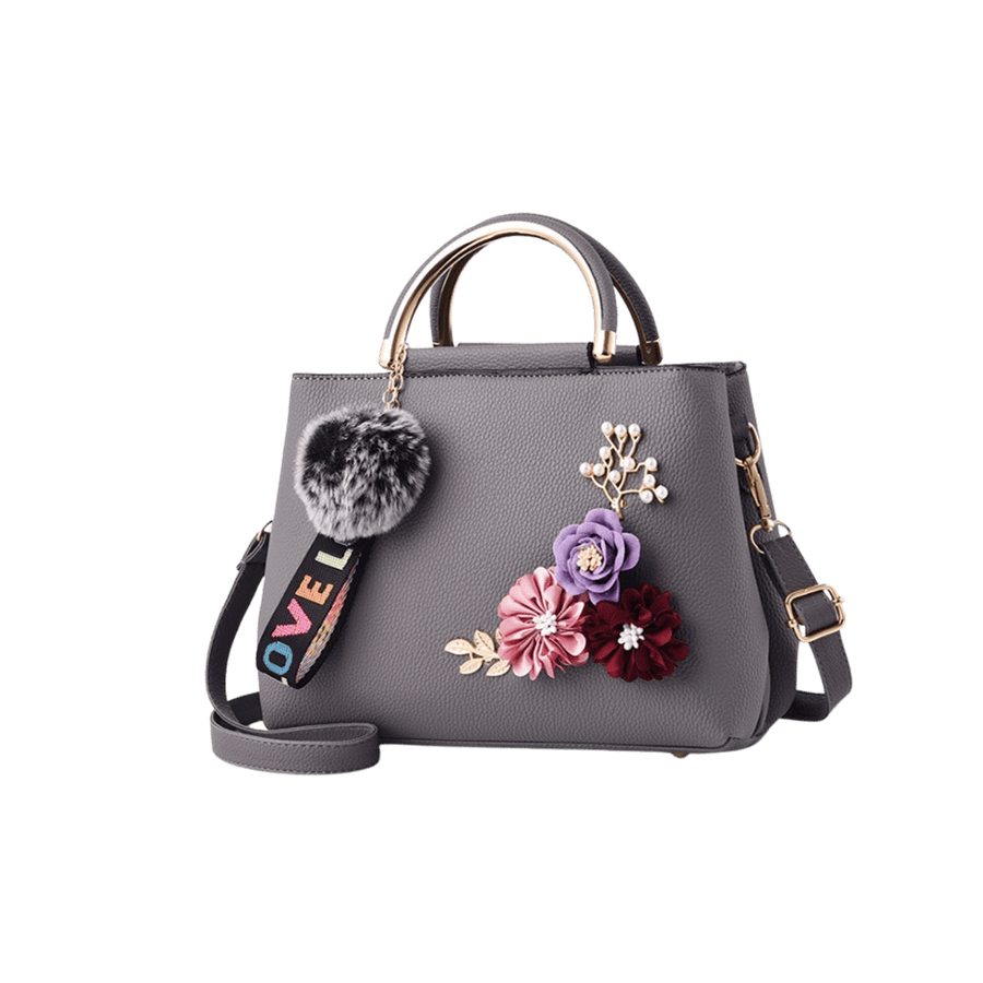 Grey ladies handbag with decorative flowers and detachable pompom