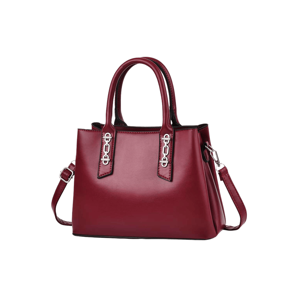 Burgundy ladies handbag with decorative hardware on the handle and contrast edge painting