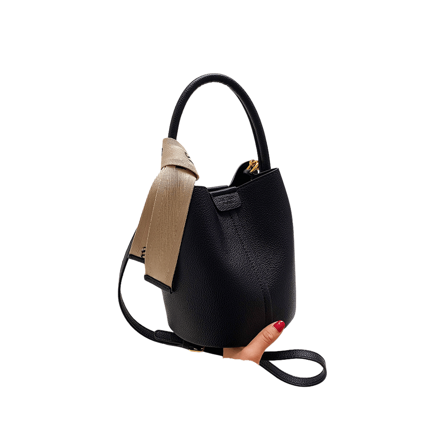 Black ladies bucket bag with beige webbing on the handle and magnetic snap closure