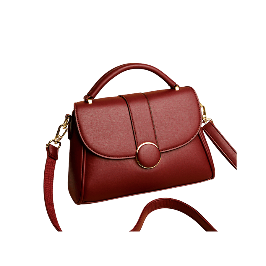 Burgundy ladies handbag with decorative round hardware on the flap and magnetic snap closure