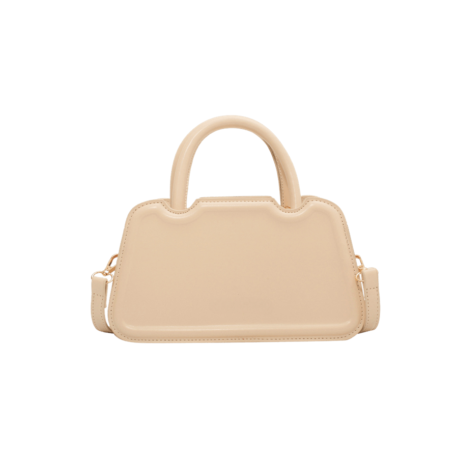 Beige ladies handbag with bombe on the front and tubular handle