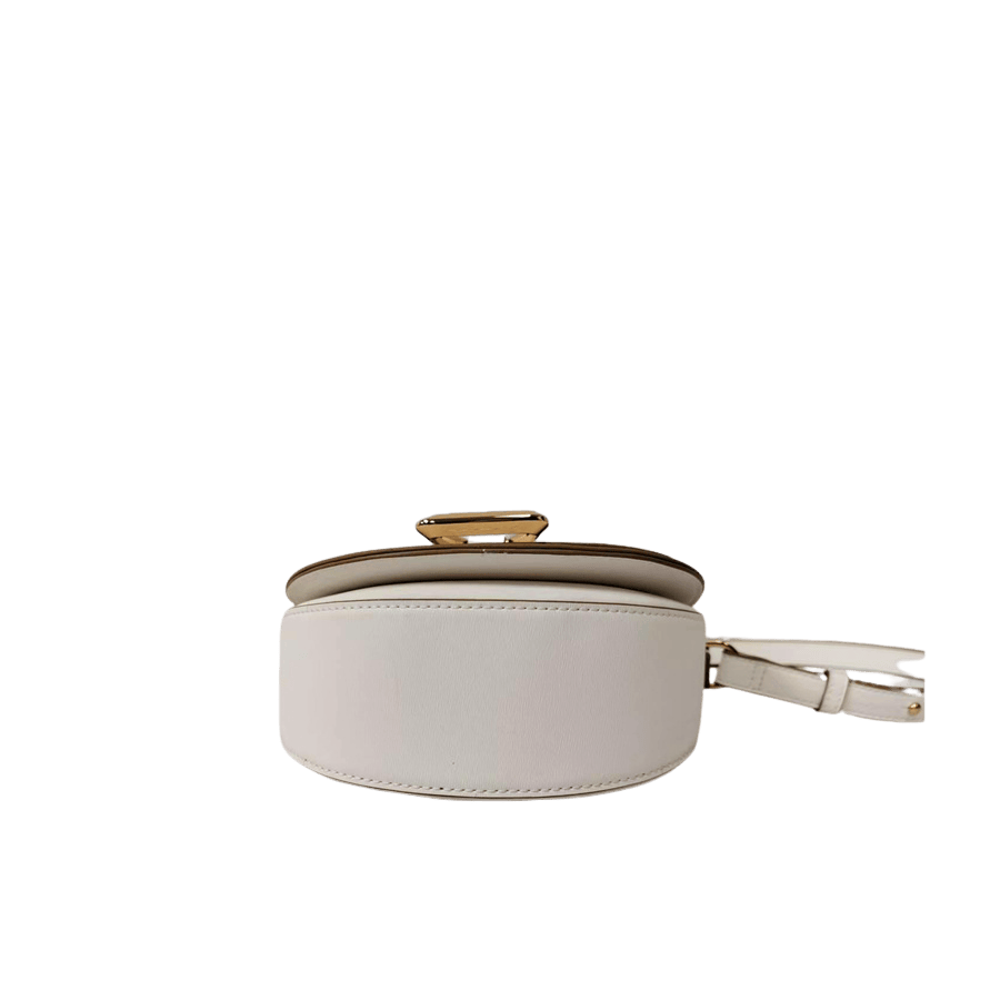 White ladies crossbody bag with decorative  hardware on the flap and contrast edge painting