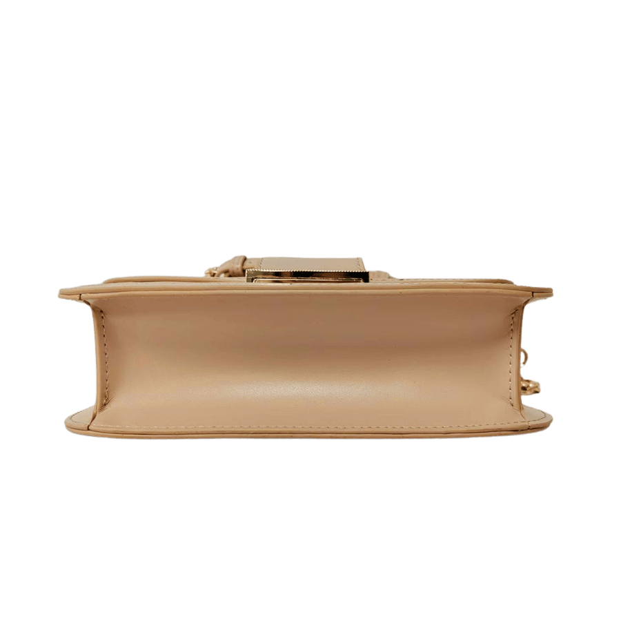 Crossbody bag with lock closure and metal plate on the back