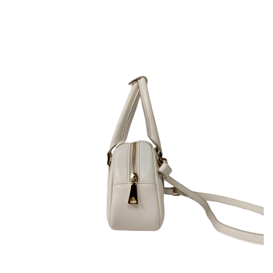 White ladies handbag with metal feets and piping around the body