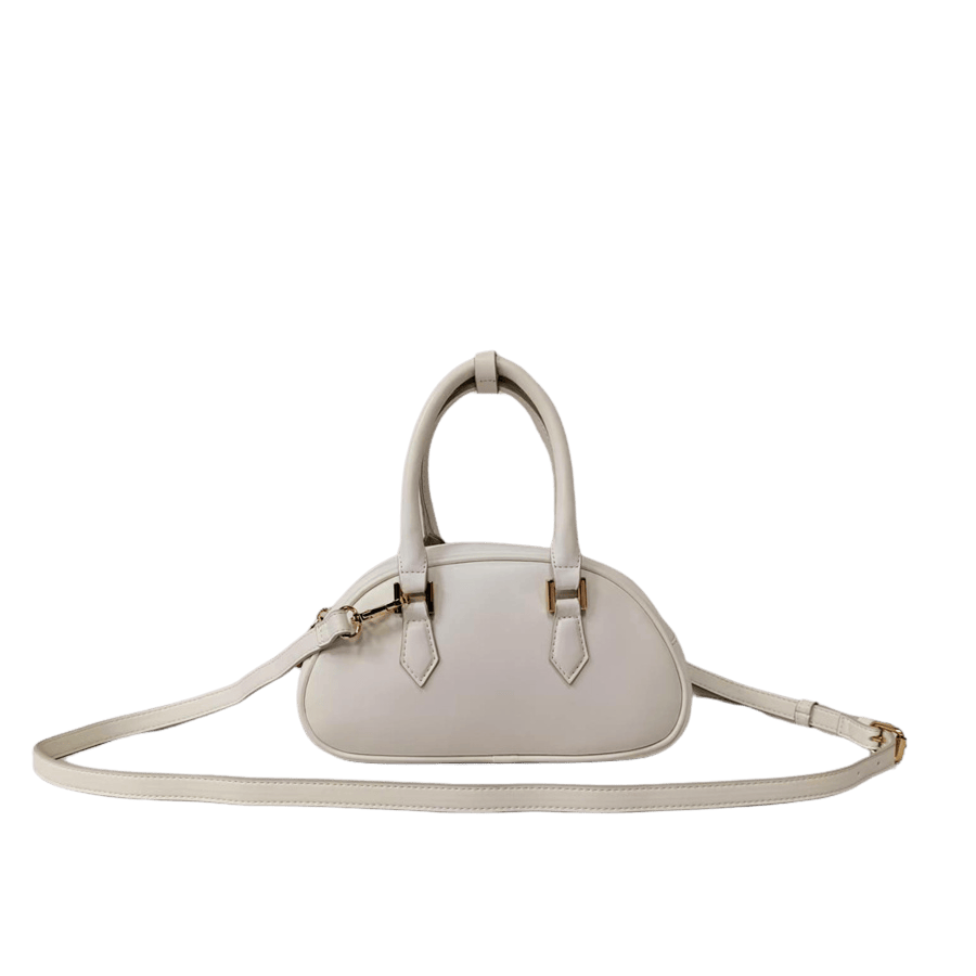 White ladies handbag with metal feets and piping around the body