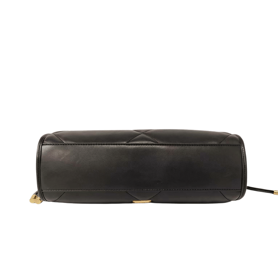Black quilting ladies handbag with metal plate and string closure on the gussets