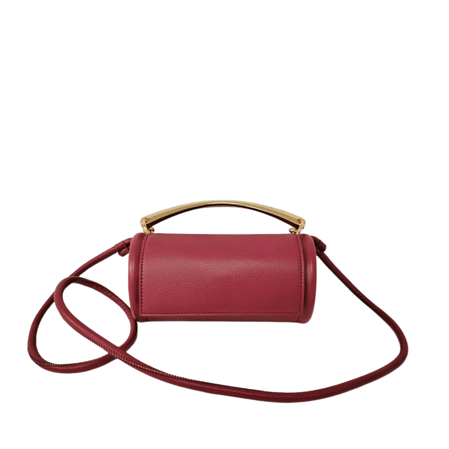 Beige cylinder ladies crossbody bag with metal handle and magnetic snap closure