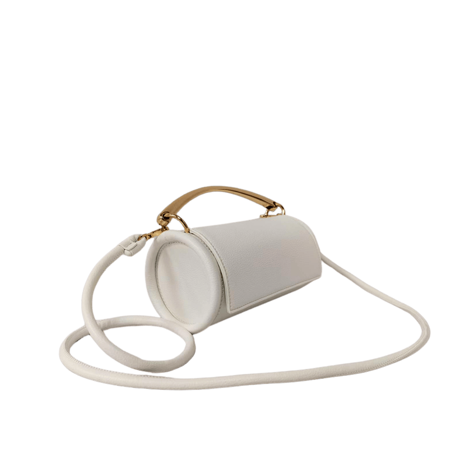 Beige cylinder ladies crossbody bag with metal handle and magnetic snap closure