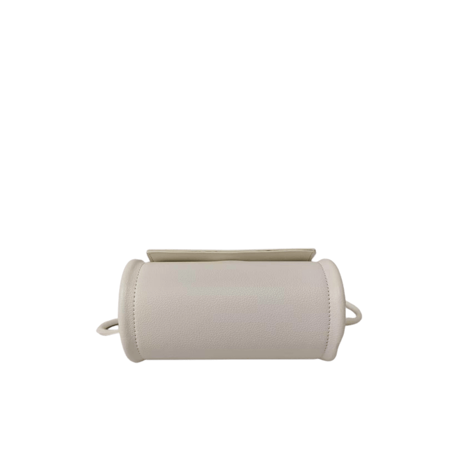 Beige cylinder ladies crossbody bag with metal handle and magnetic snap closure