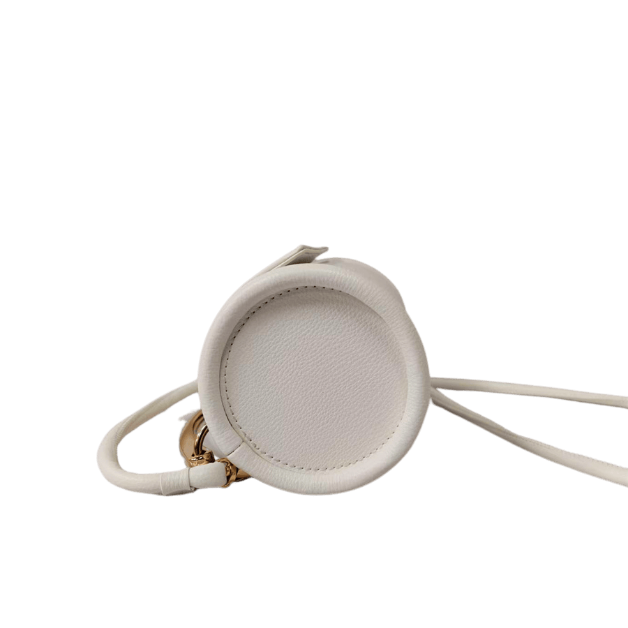 Beige cylinder ladies crossbody bag with metal handle and magnetic snap closure