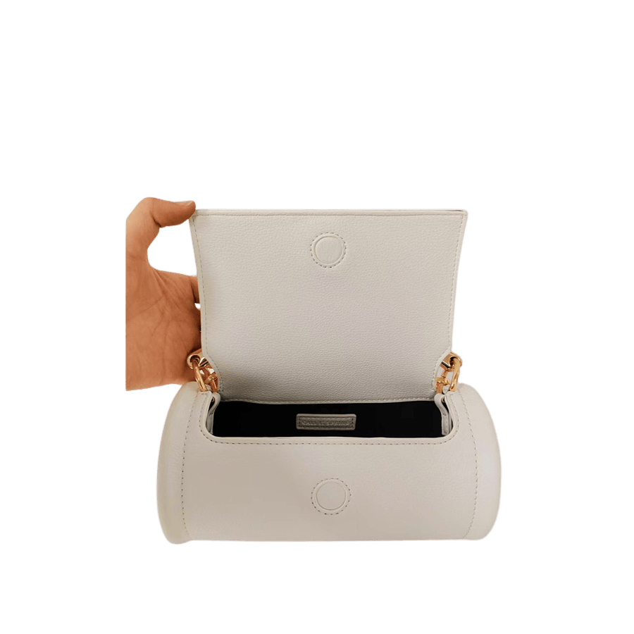 Beige cylinder ladies crossbody bag with metal handle and magnetic snap closure