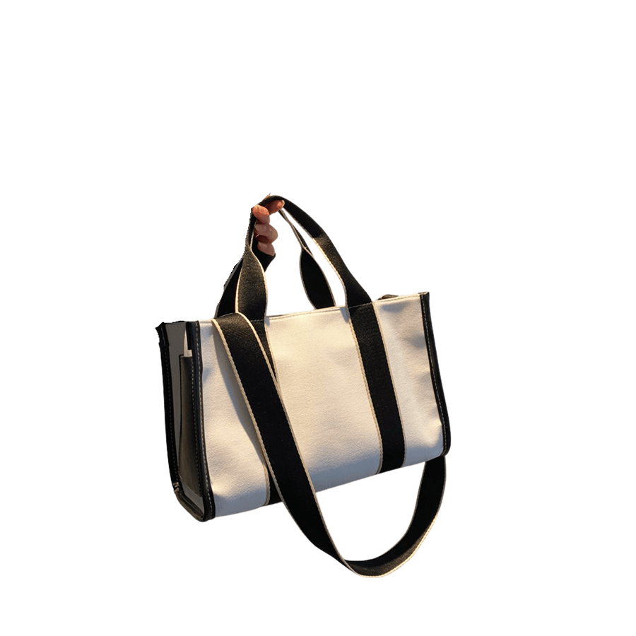 White canvas ladies tote bag with black trim canvas and stripe webbing