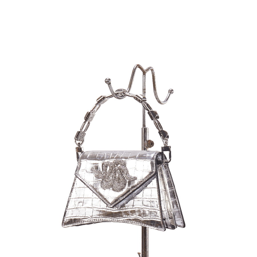 Silver ladies handbag with chain handle and decorative snake hardware on the flap