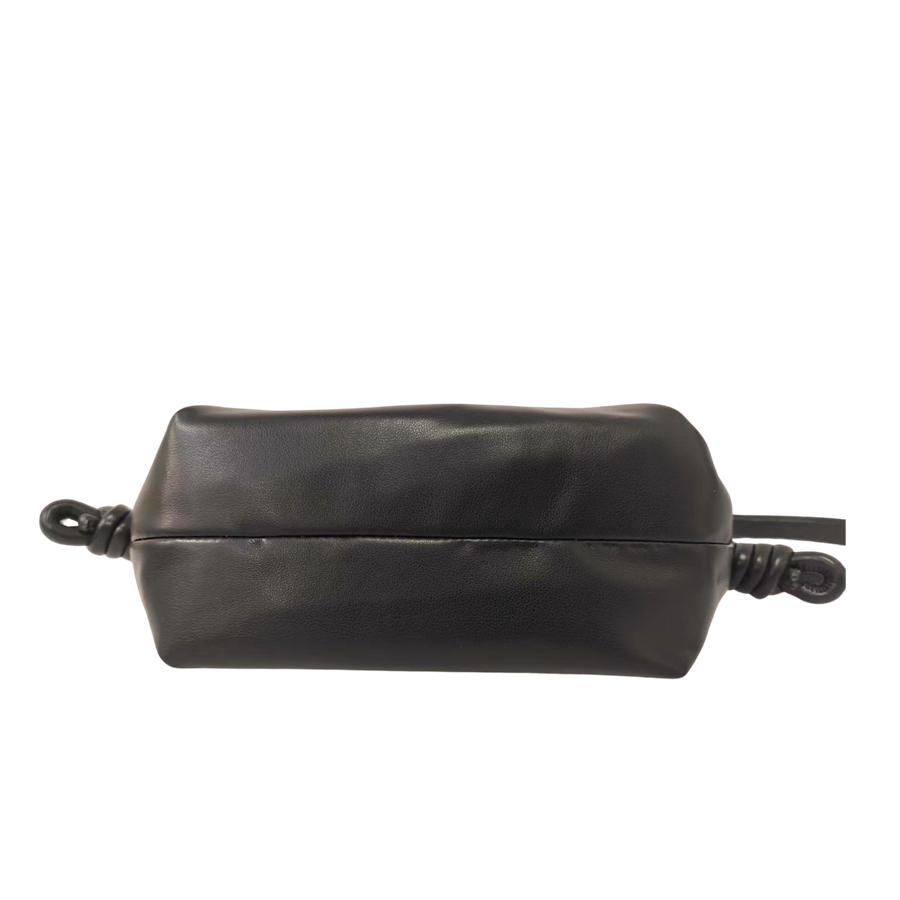 Black ladies handbag with pleats and knots on the handle