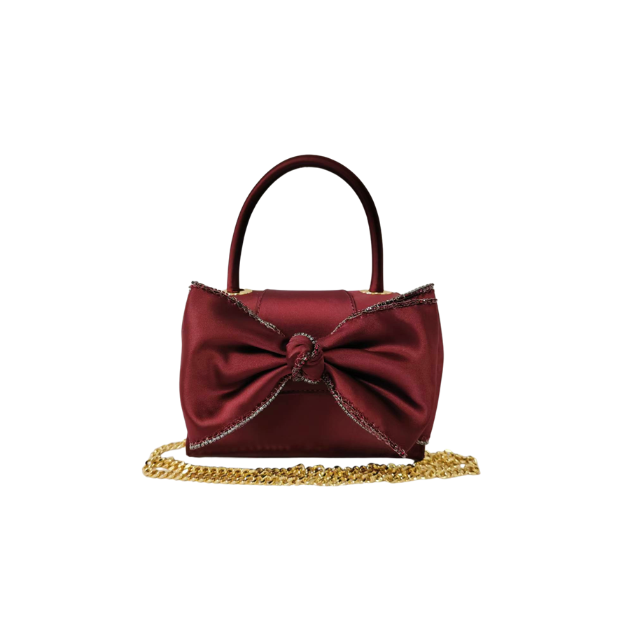 Burgundy ladies handbag with big bowknot and decorative eyelets on the top