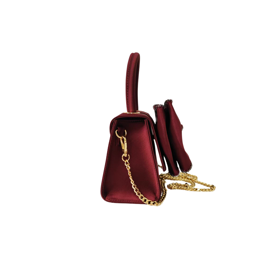Burgundy ladies handbag with big bowknot and decorative eyelets on the top
