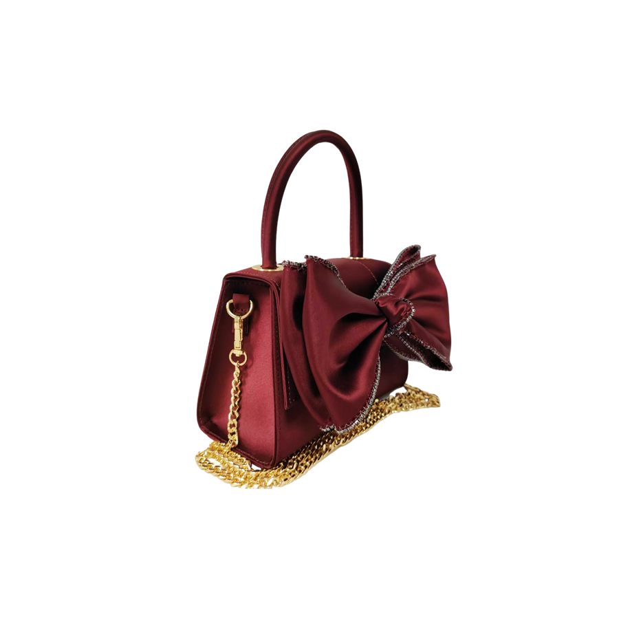 Burgundy ladies handbag with big bowknot and decorative eyelets on the top