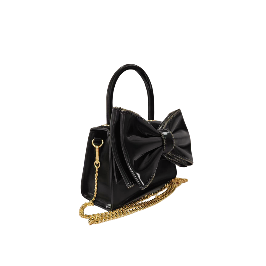 Burgundy ladies handbag with big bowknot and decorative eyelets on the top