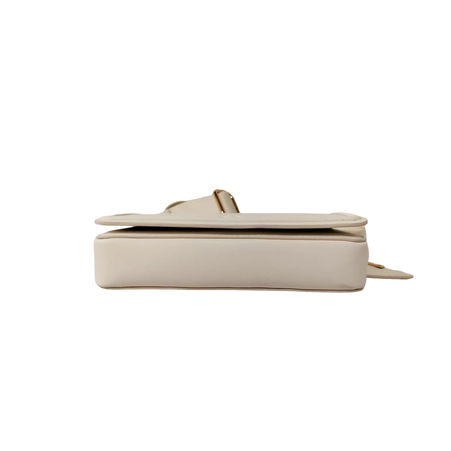 Beige ladies crossbody bag with decorative bombe and magnetic snap closure